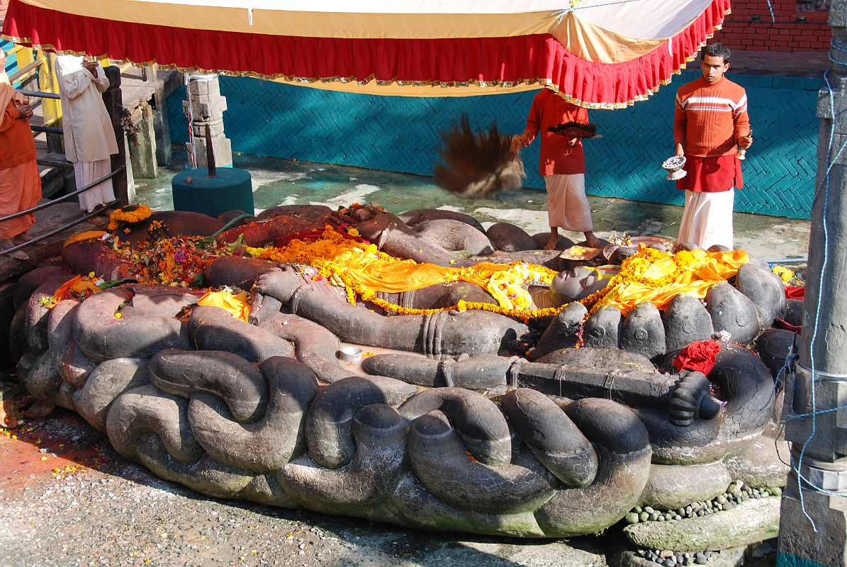 Kathmandu Valley 1 Budhanikantha 1 Hindu Priests Perform Ceremony At Budhanikantha Sleeping Vishnu Statue Hindu priests perform a ceremony around 9am at Budhanilkantha Narayan (Sleeping Vishnu), 15km north from Thamel in Kathmandu. The 5m long great stone figure of the Hindu god Vishnu reclines on the coils of the cosmic serpent Ananta, lying in a 13m long tank.